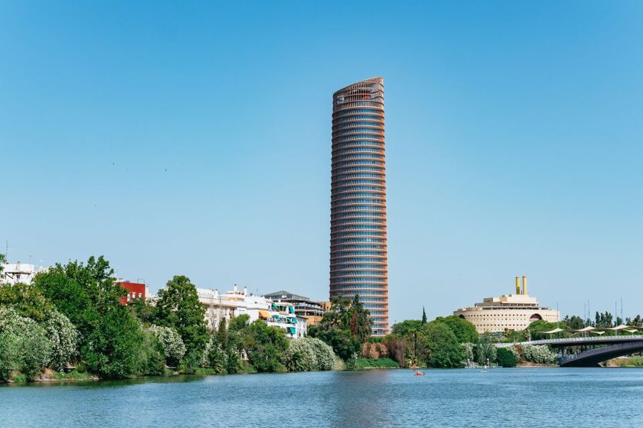 Seville: 1-Hour Guadalquivir River Sightseeing Eco Cruise - Old towers beside modern Seville