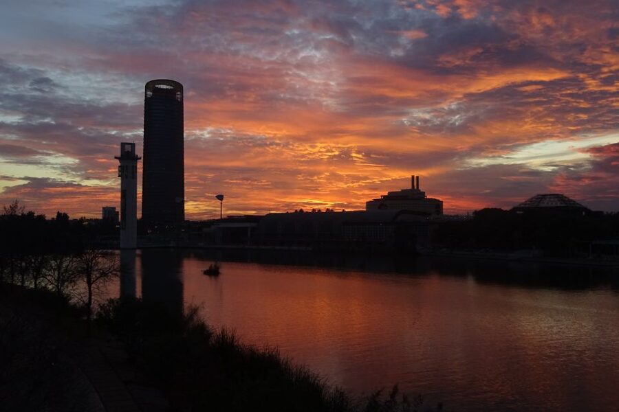 Seville: 2.5-Hour Evening Electric Bike Tour - Crossing toward Triana as the lights come on