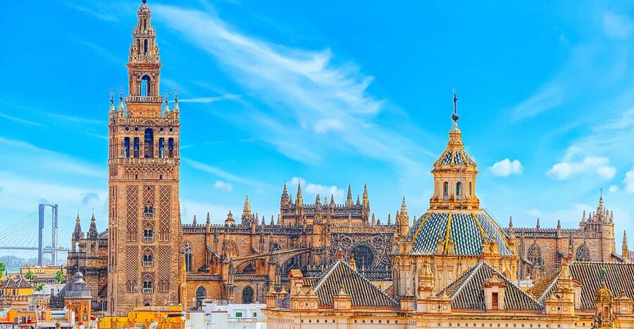 La Giralda and the Gothic cathedral above the rooftops of Seville