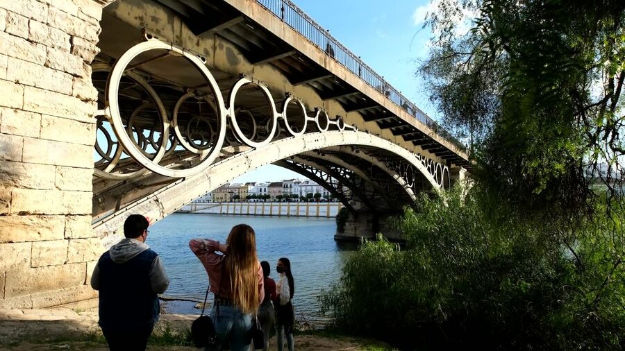Seville: Guadalquivir & Secrets of Triana Small Group Tour - Crossing into Triana over Isabel II Bridge