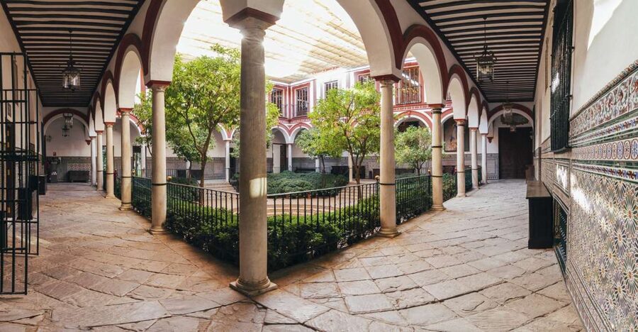 Seville: Hospital de los Venerables Ticket with Audio Guide - Entering the courtyard beneath old wooden gates