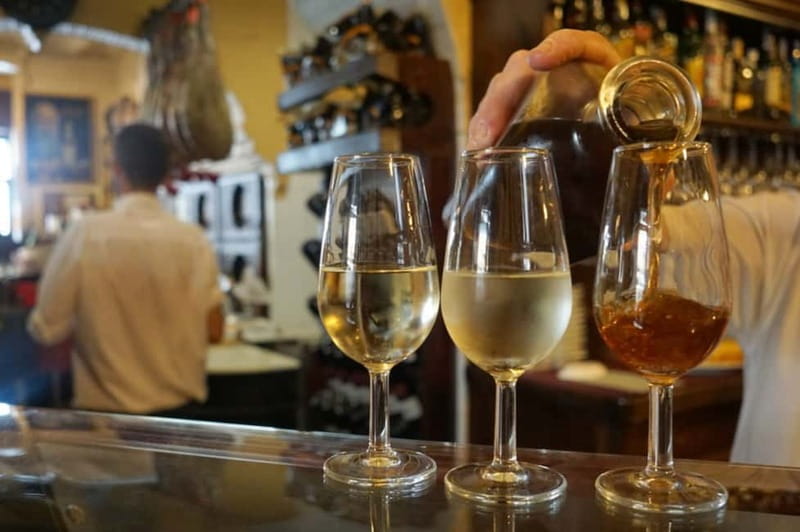 Seville: Tapas Walking Tour with Traditional Flamenco Show - The first stop: cured meats, vermouth, and tapas lessons